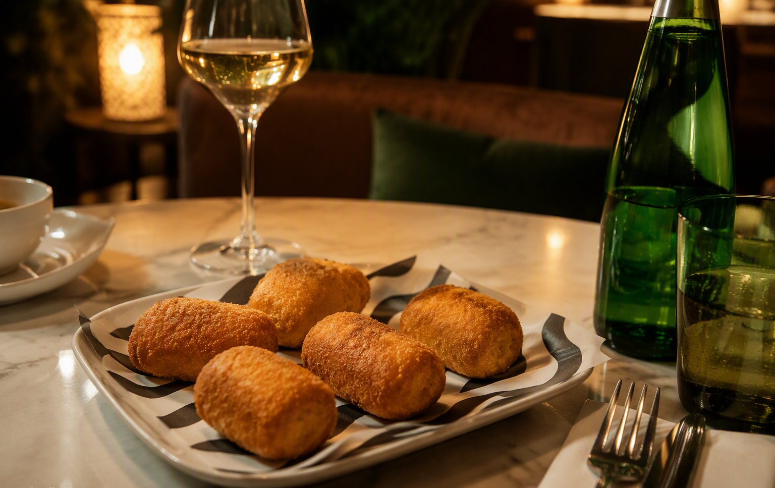 Homemade croquetas on RAW-branded paper